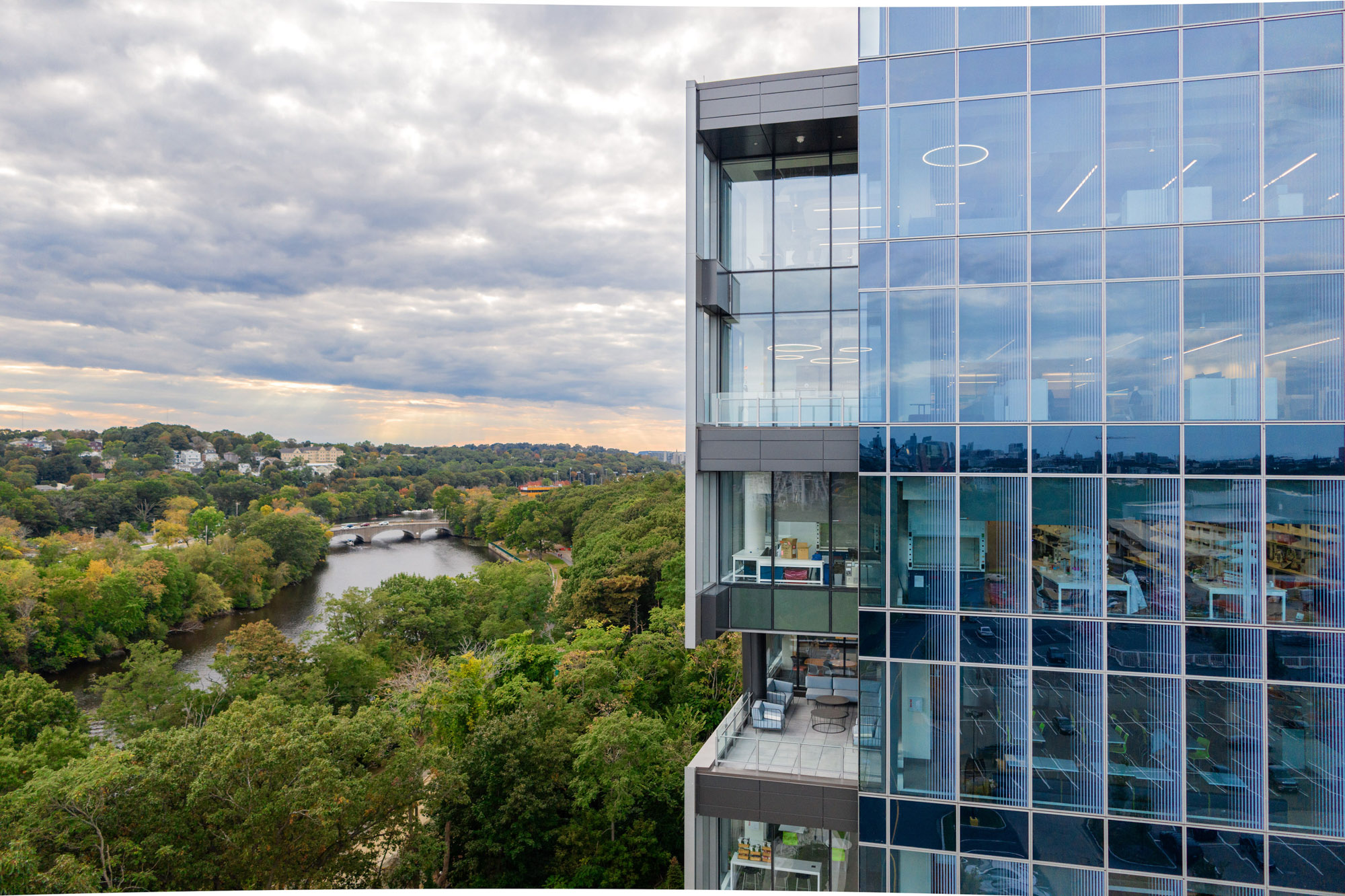 A balcony at 100 Forge provides spectacular views of the nearby Charles River.