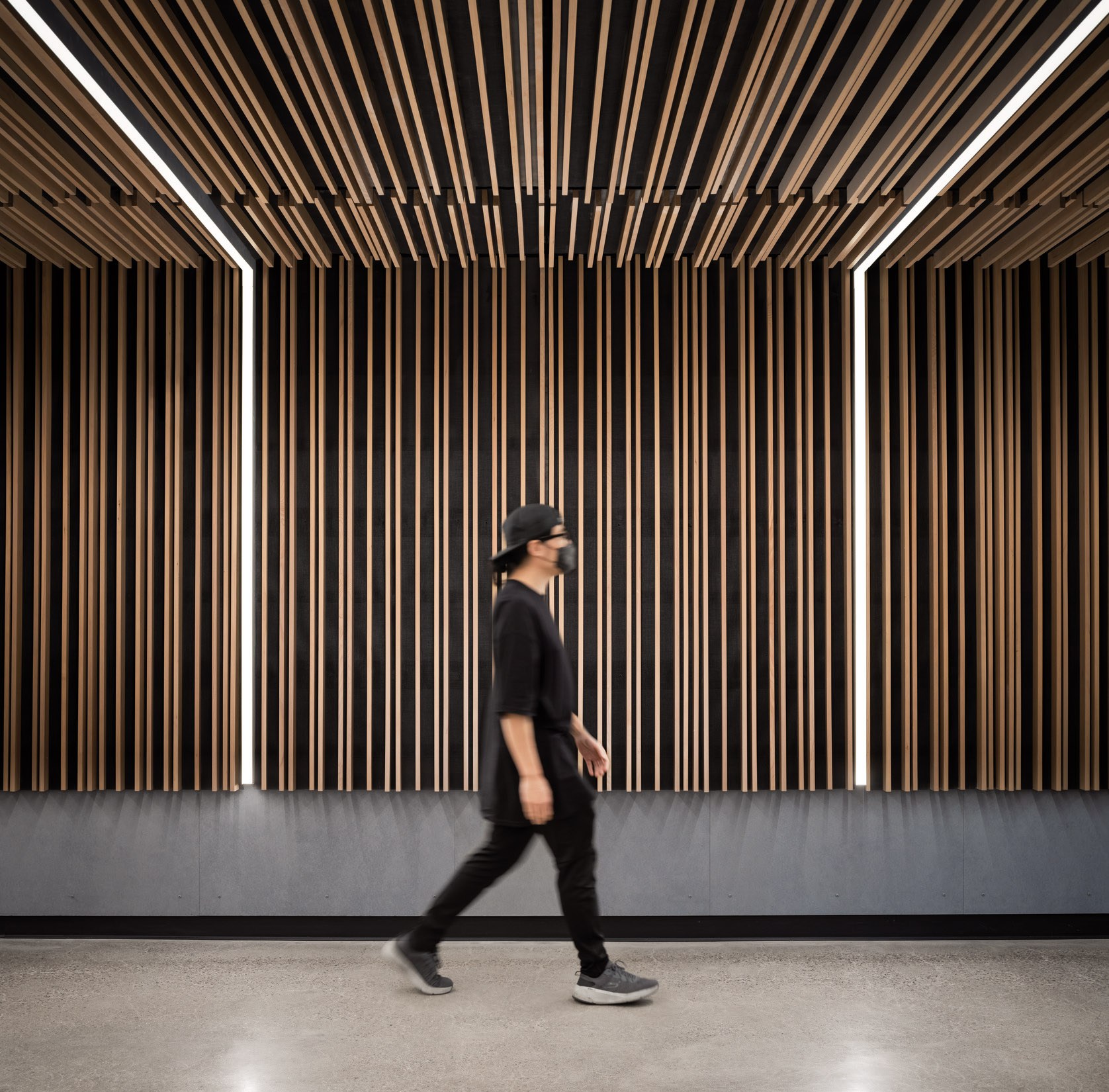 Detail at Arizona State University's Durham Hall shows wood scrim and integrated lighting at wall...