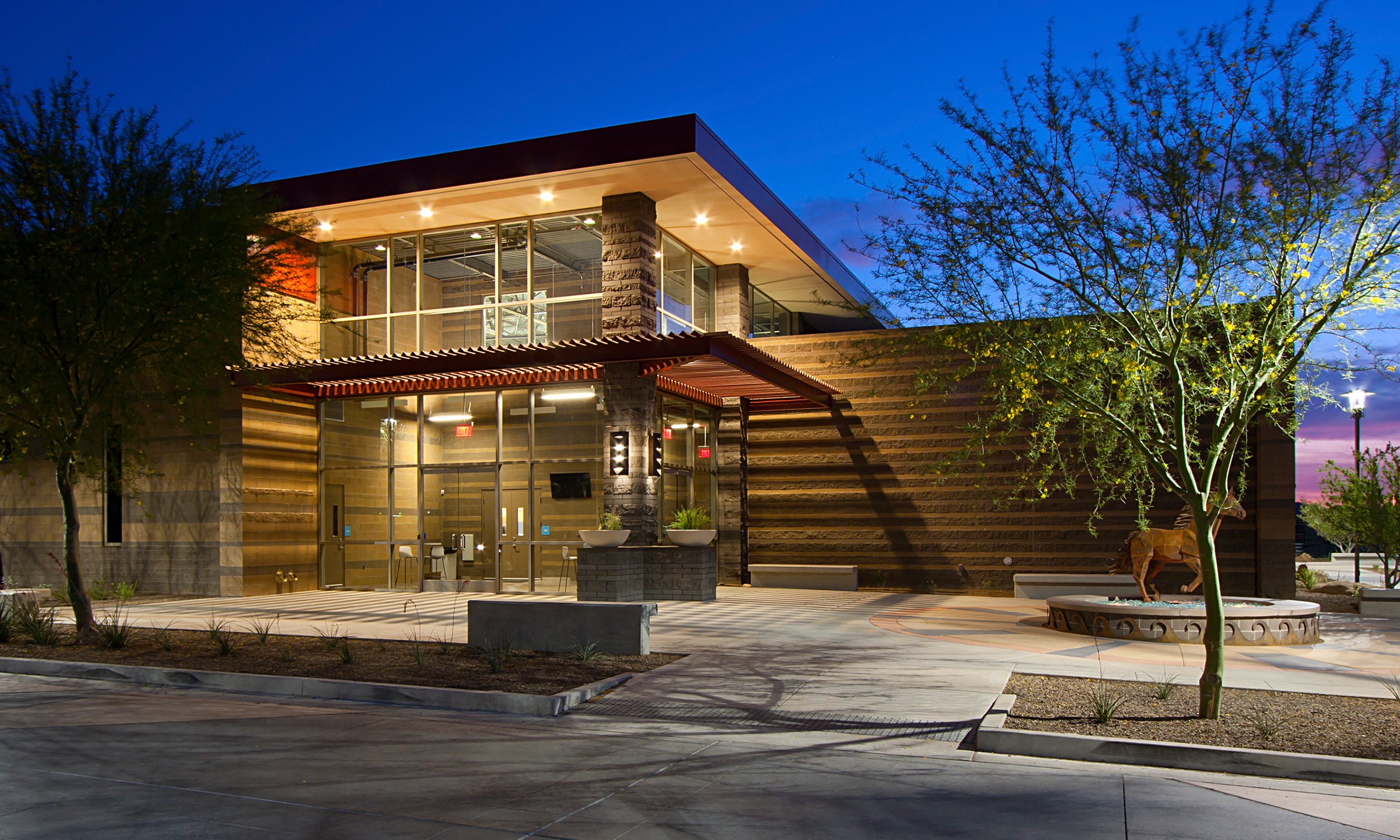 Student activity center exterior at dusk for Meritas Family of Schools