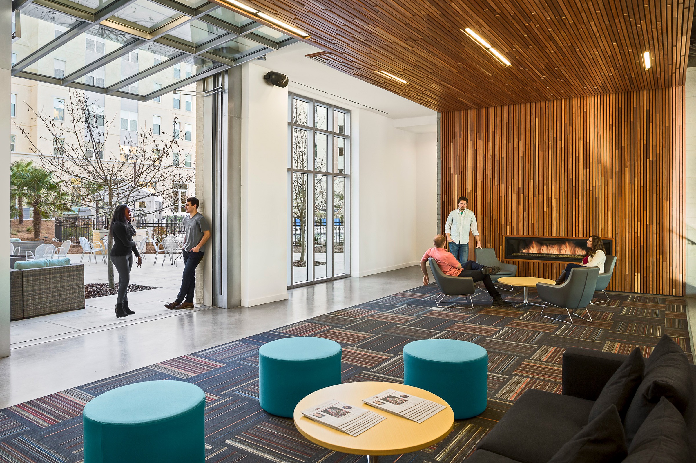 Interior view of residents conversing in a ground floor lounge space in 650 Lincoln at the University...