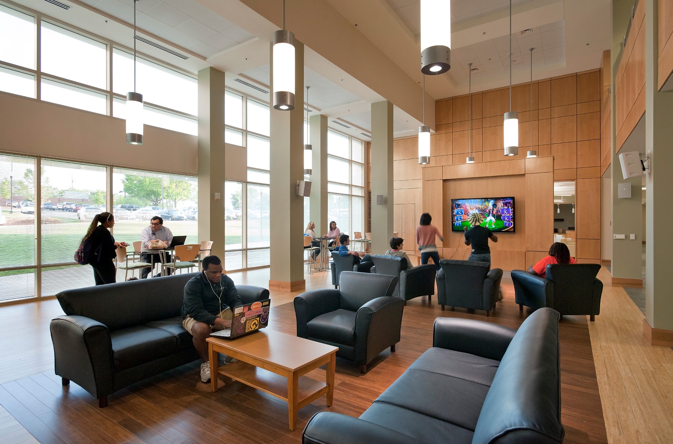 Interior view of residents studying and socializing in the common space of Jefferson Suites and...