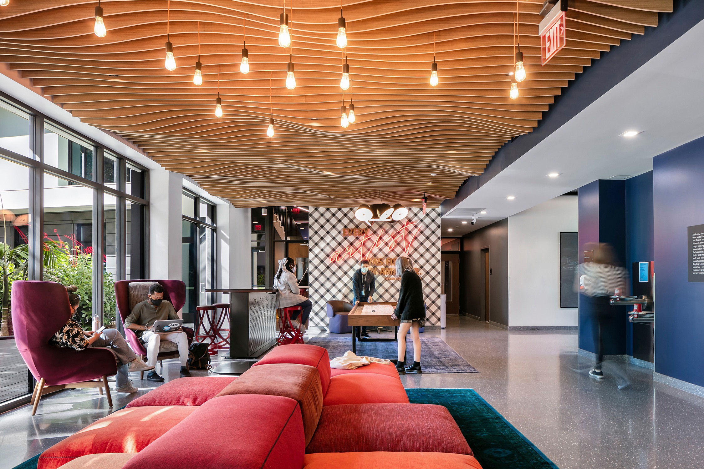 Interior view of students studying and recreating in the lounge space at Greensboro Hall at Ringling...