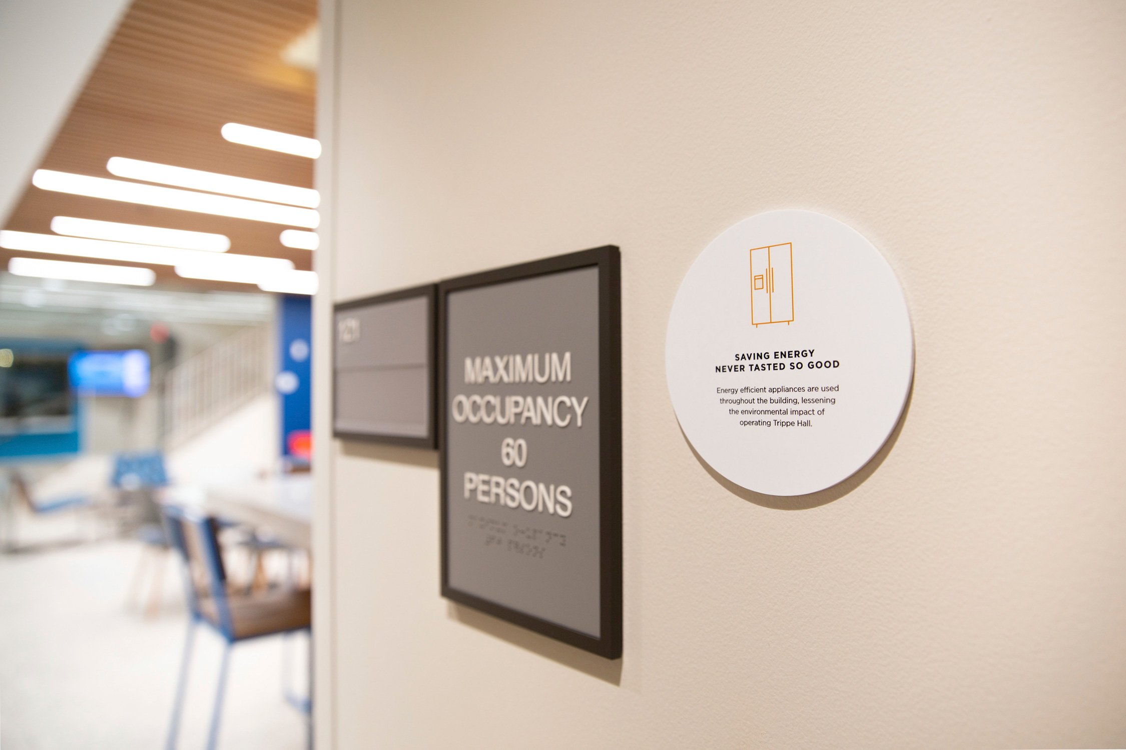 Detail of sustainability signage informing students about energy efficient appliances in the kitchen...