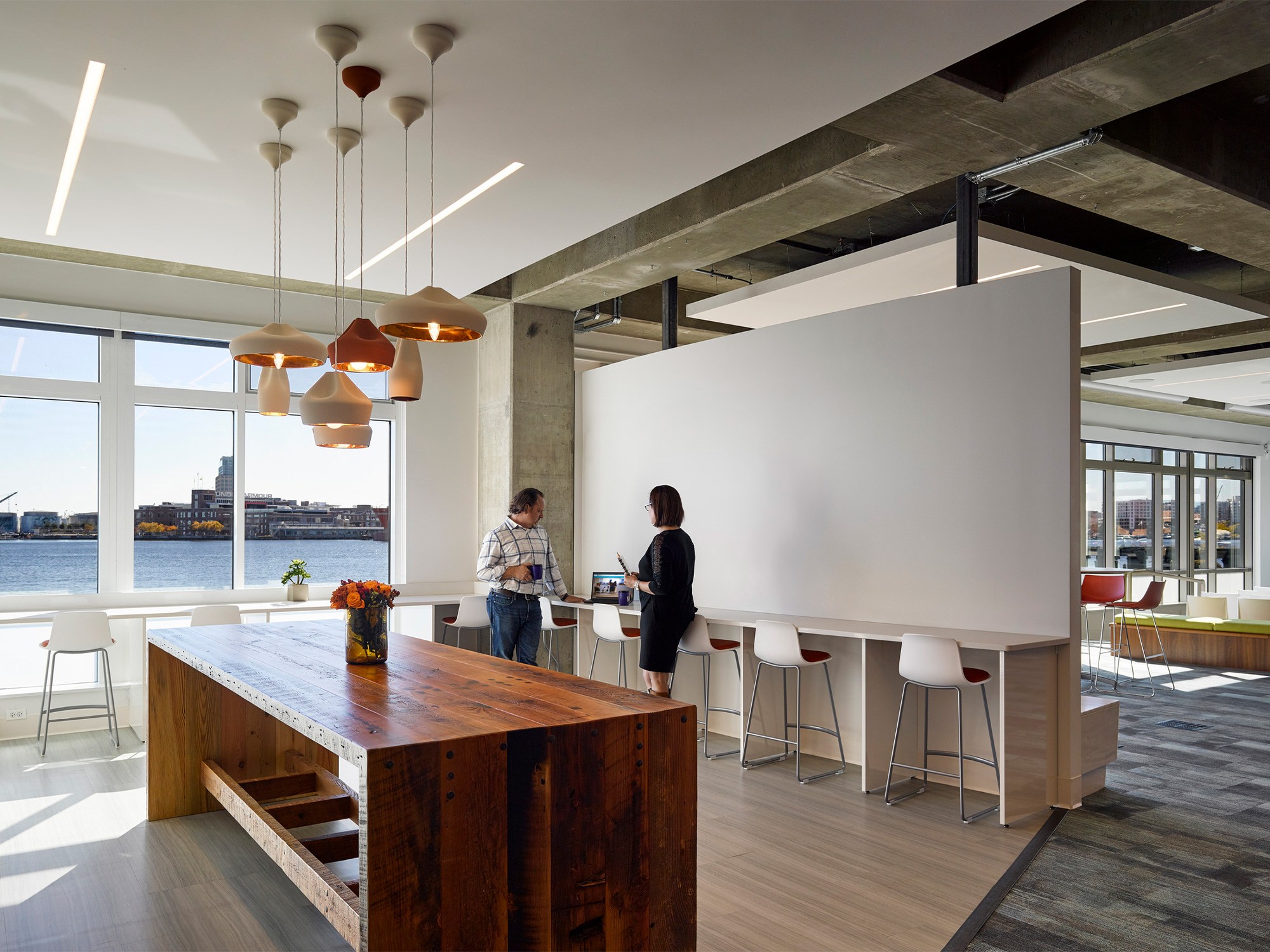 A light filled café area overlooks the Baltimore Harbor. Bar seating lines the walls and a statement...
