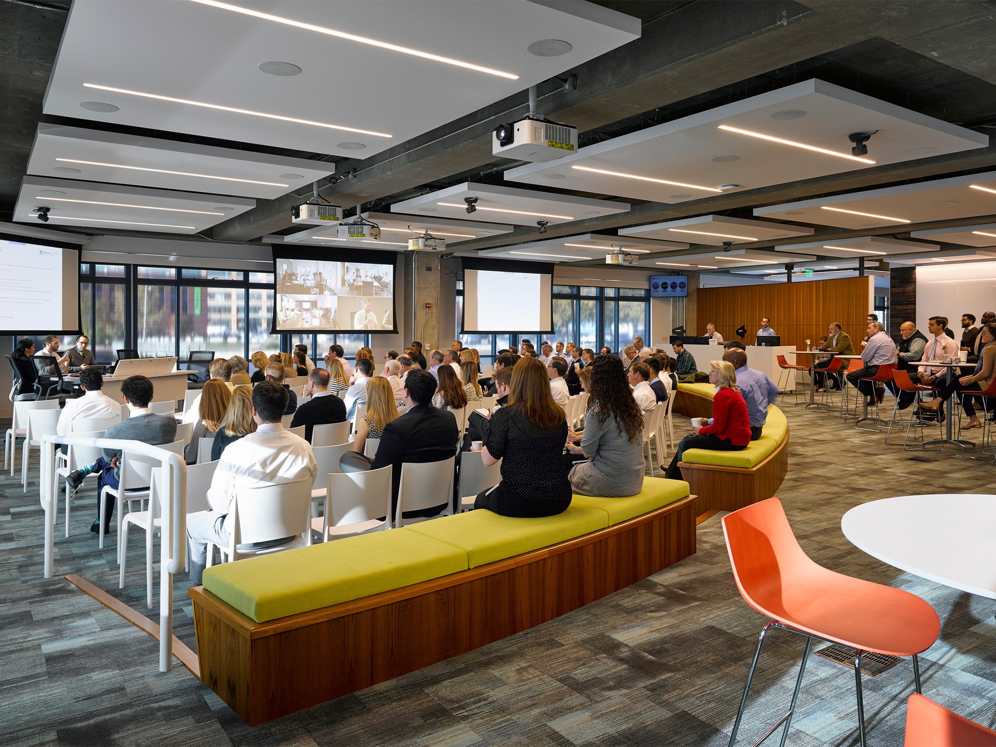 An open conference area features various levels of seating, from dining style chairs, to upholstered...