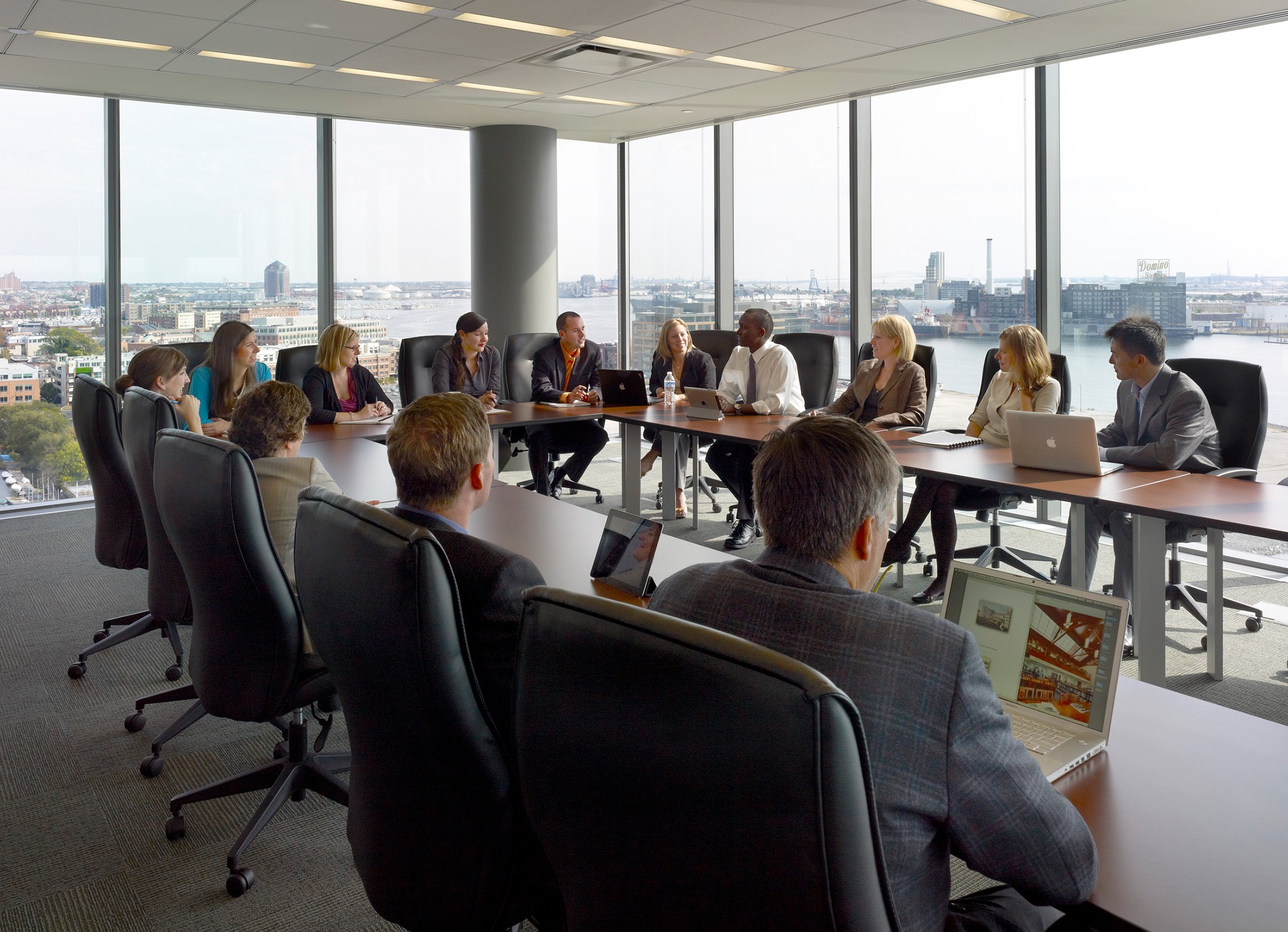 Light-filled conference room with waterfront views at the Johns Hopkins University Carey School...