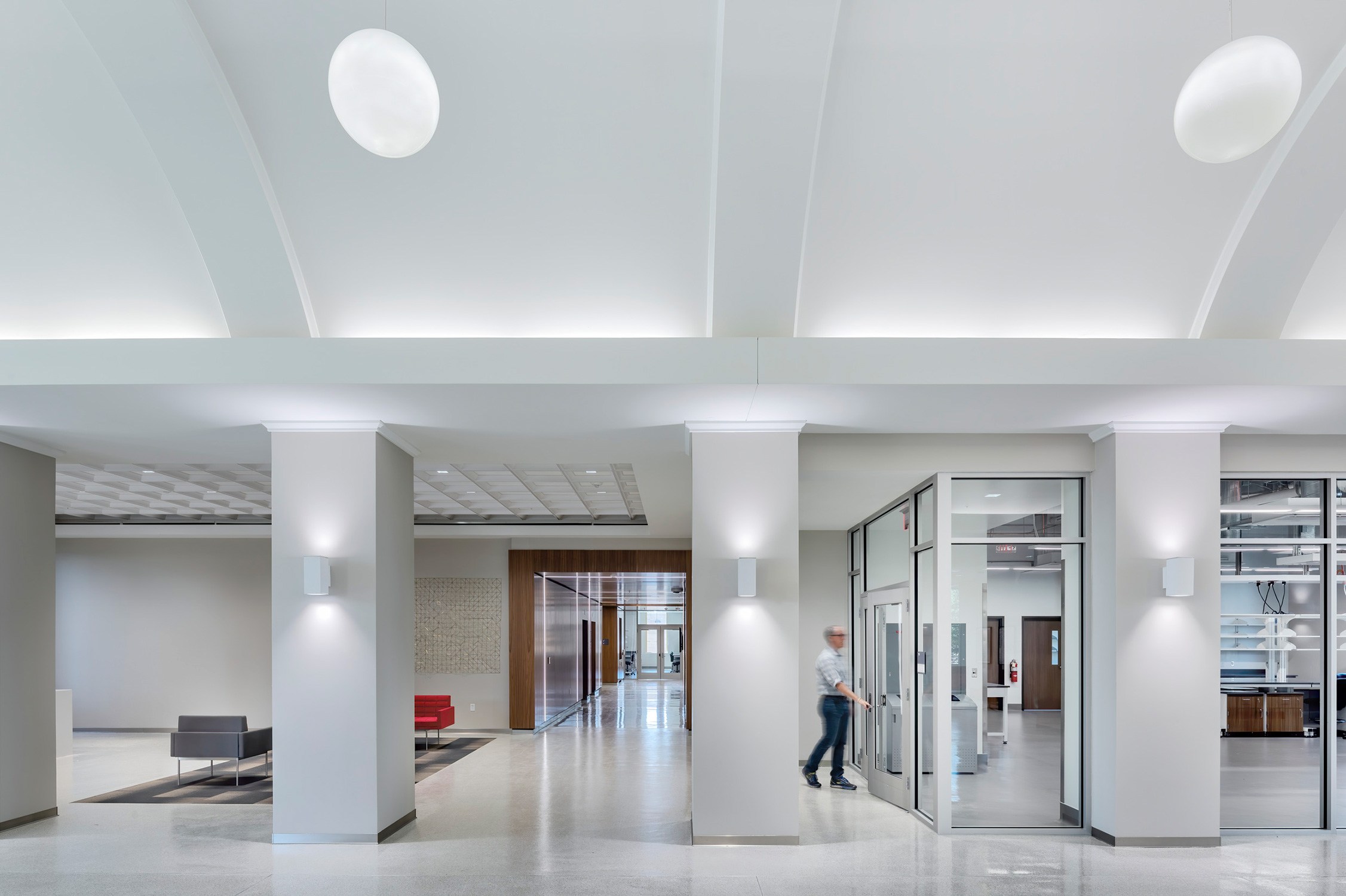 Crisp, clean atrium with views into the laboratories at the Experiential Sciences Building at Texas...