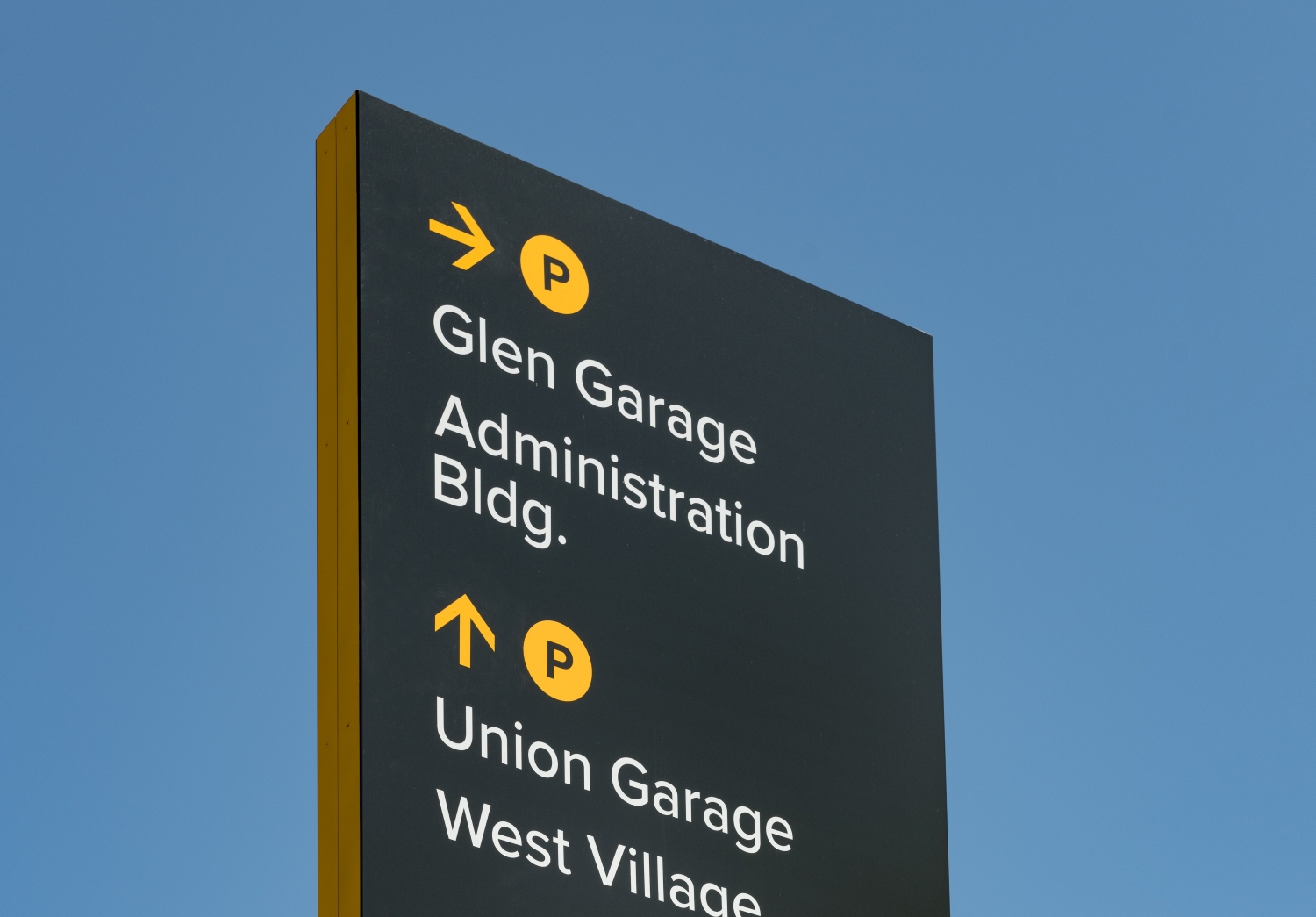 Towson University signage provides navigational and parking directions for drivers.