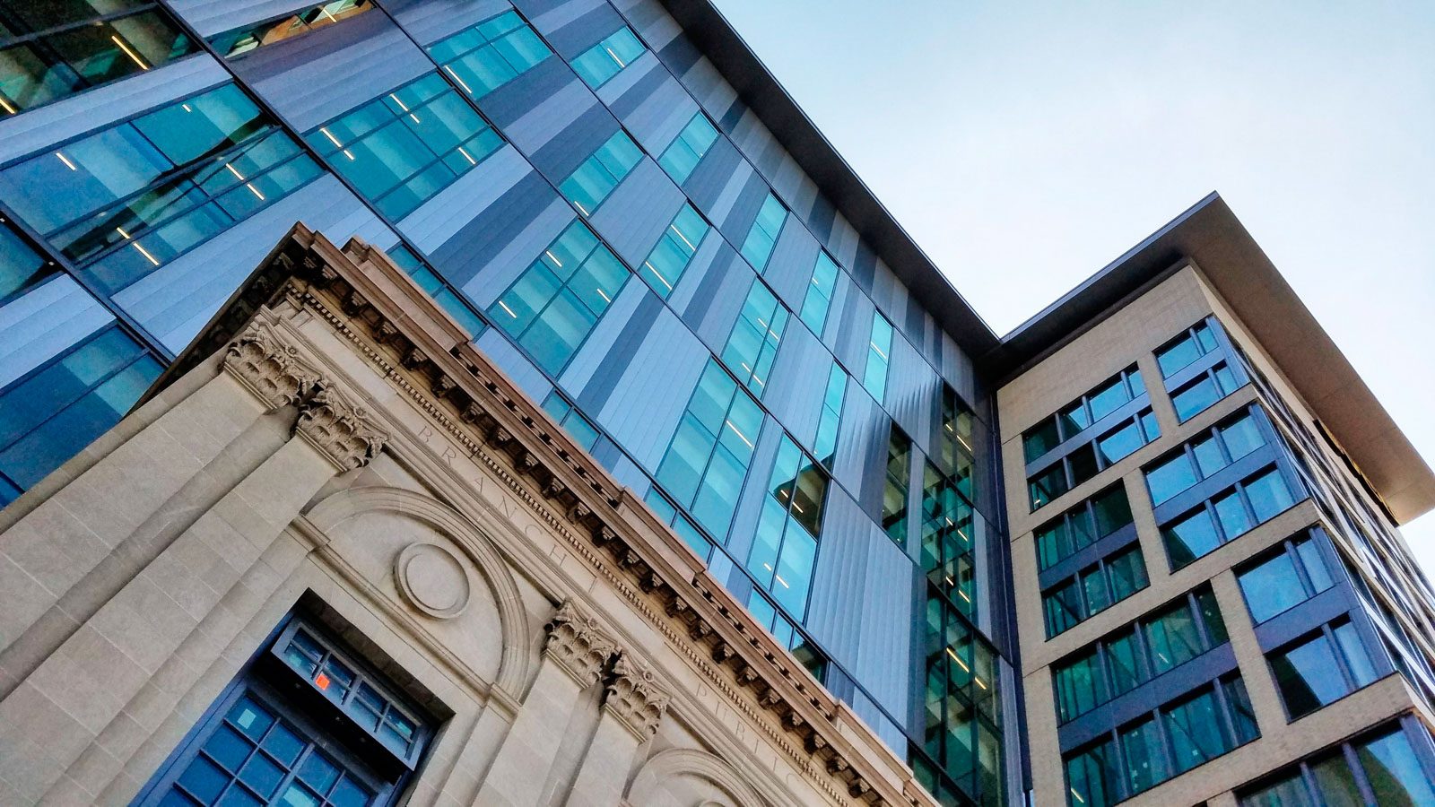 Image from the ground looking up at the historic bath house and the new façade of the Gladding...