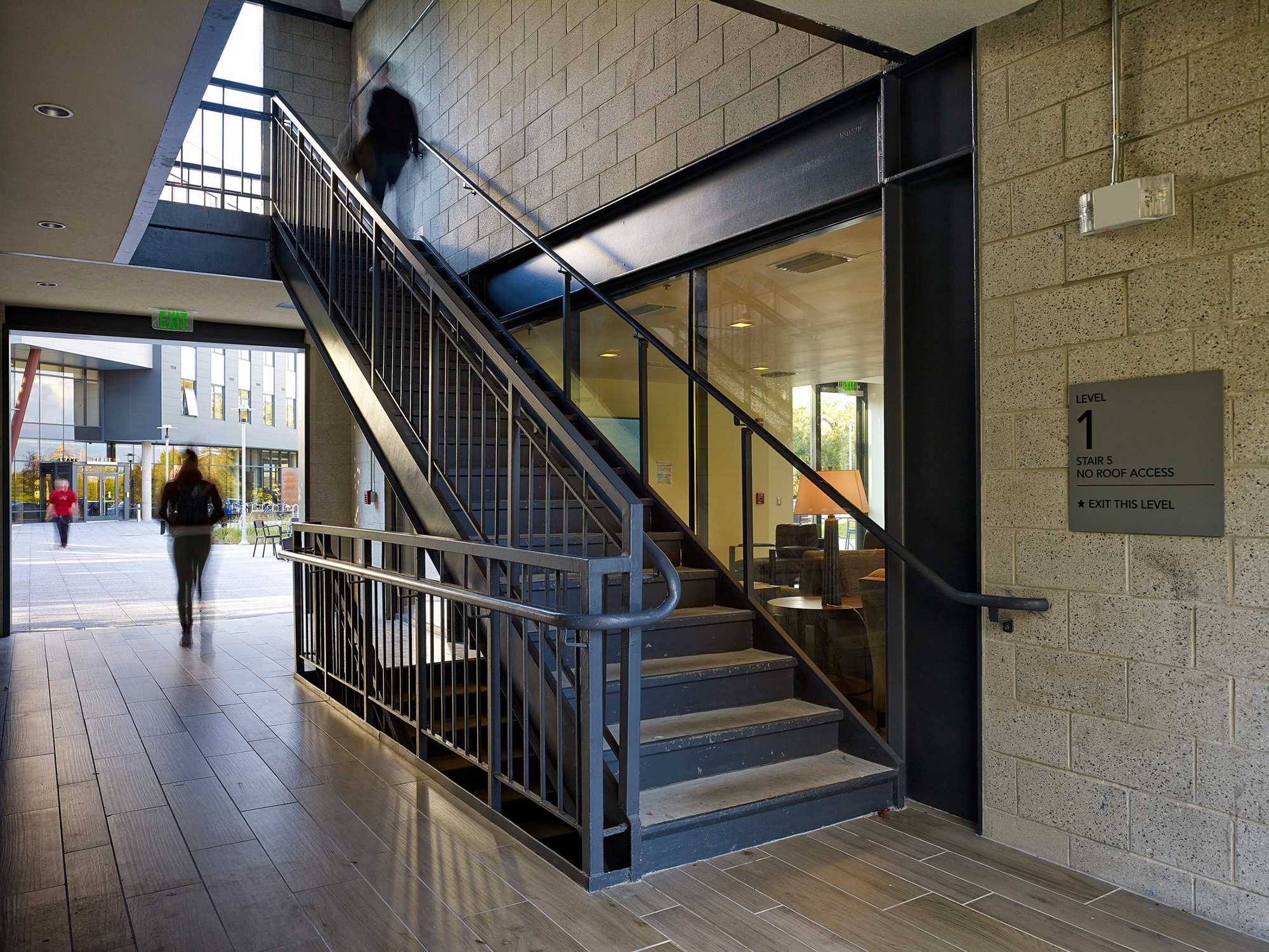 View of complex stairwell in foreground with view to city exterior in background at Founders Green...