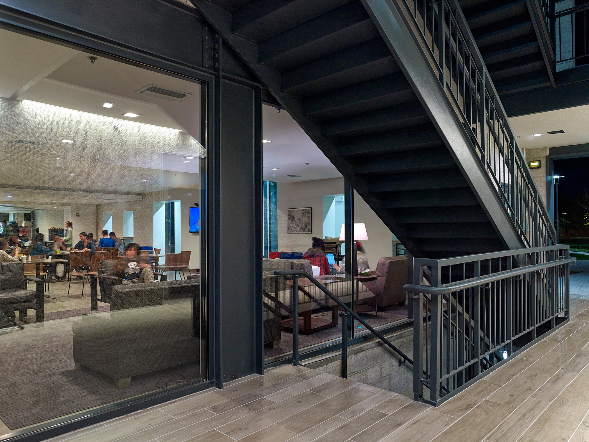 View of complex stairwell with a view into the café and lounge beyond