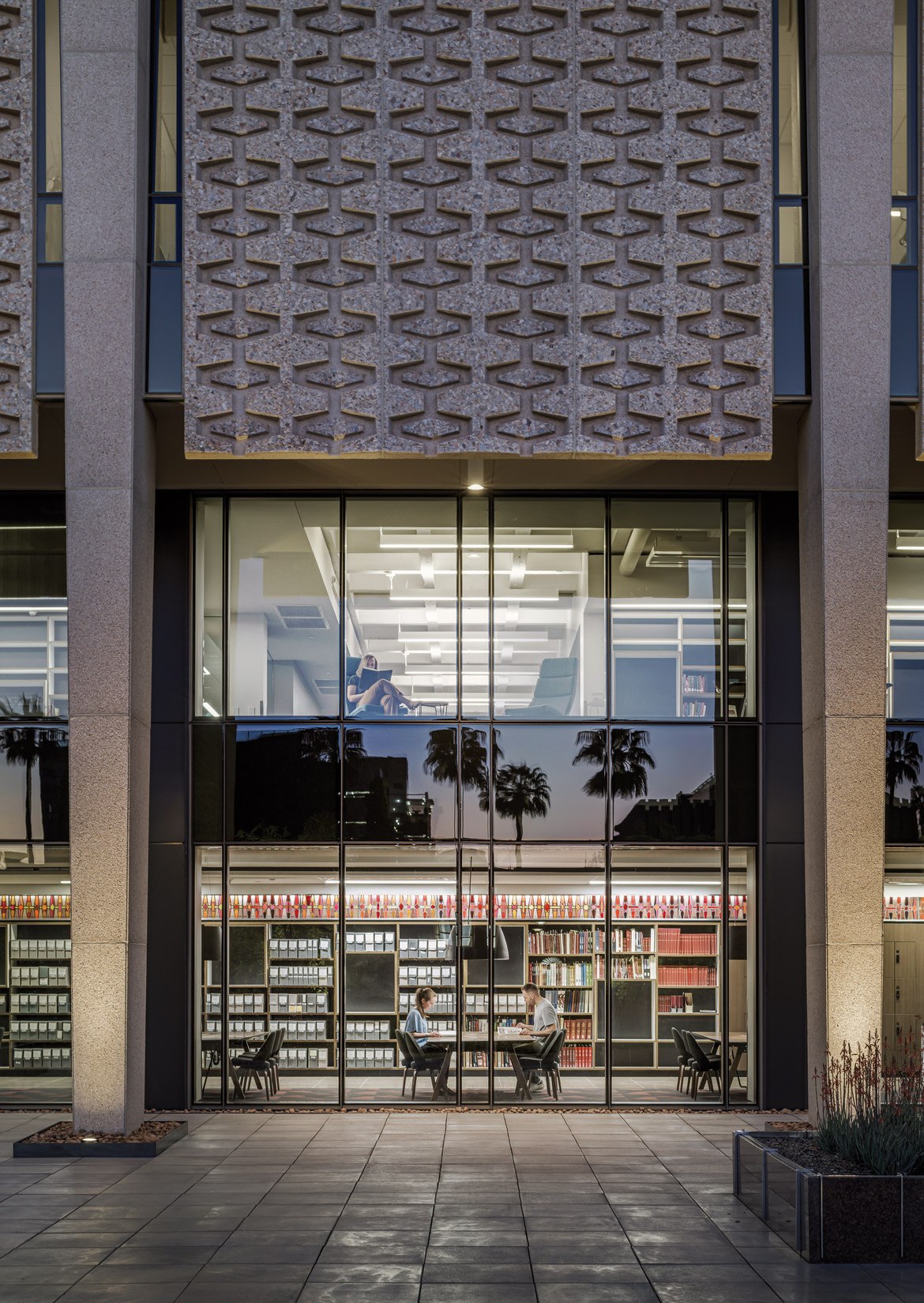 An exterior view looking into the building interiors showing repurposed stained glass and library...