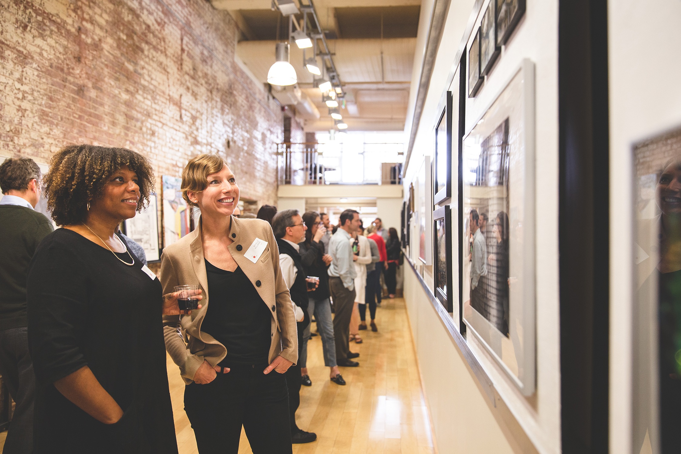 Employees look at art during a firm-wide art exhibit. in our Baltimore office.
