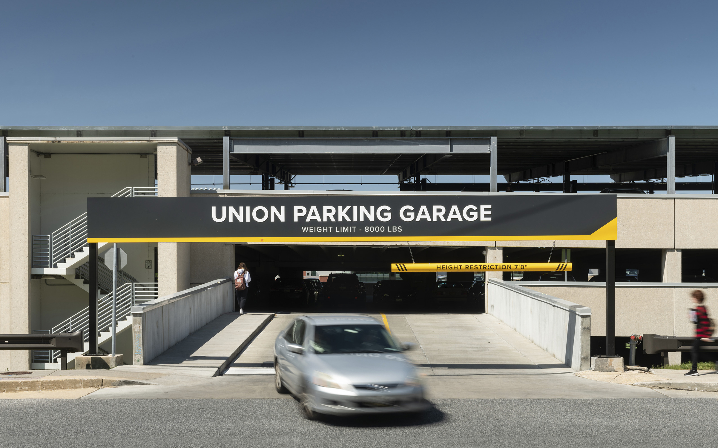 A bold sign provides parking information at Towson University's Union Parking Garage