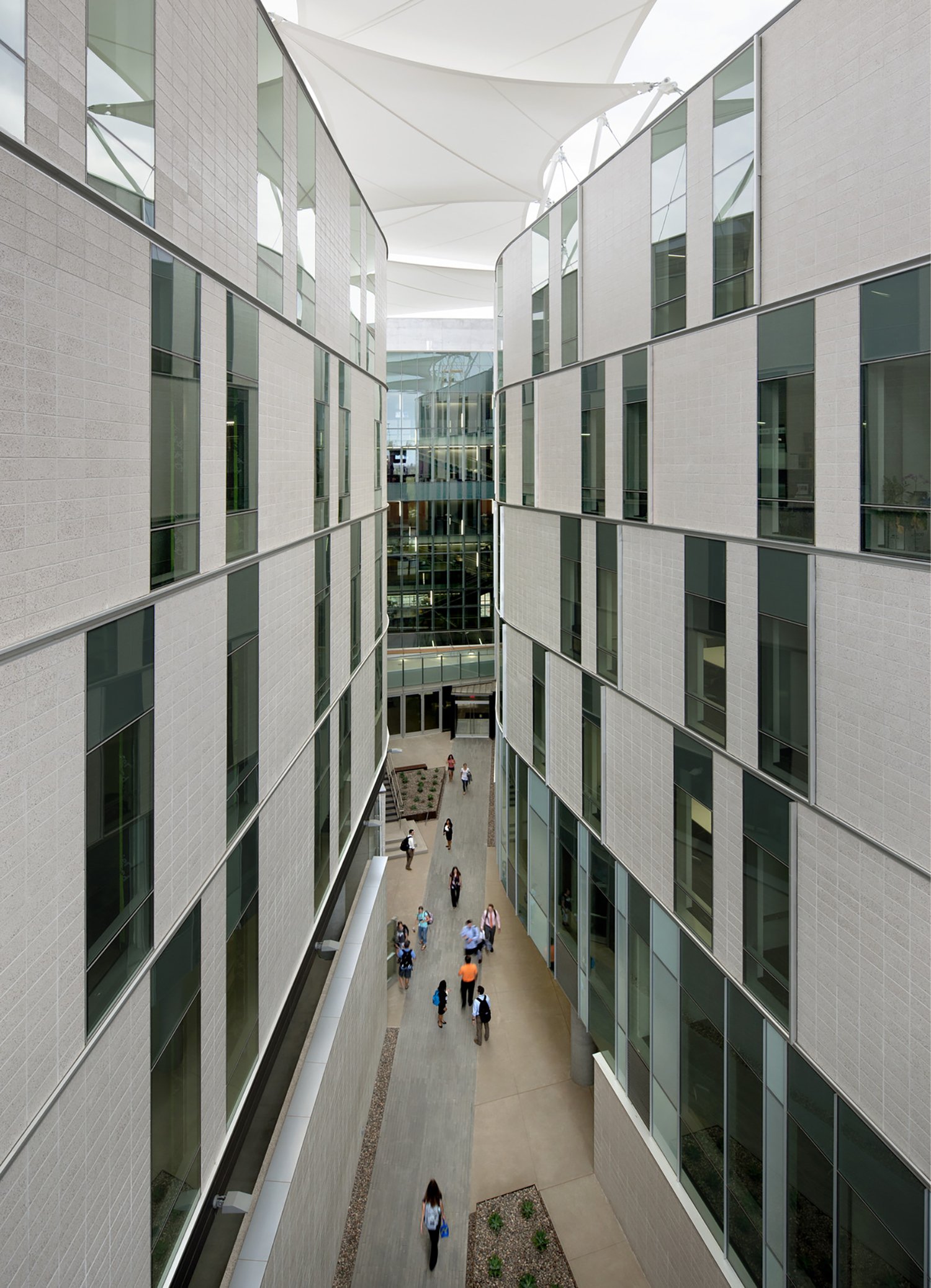 Interior breezeway flanked by exterior walls with window and a canopy overhead at the University...