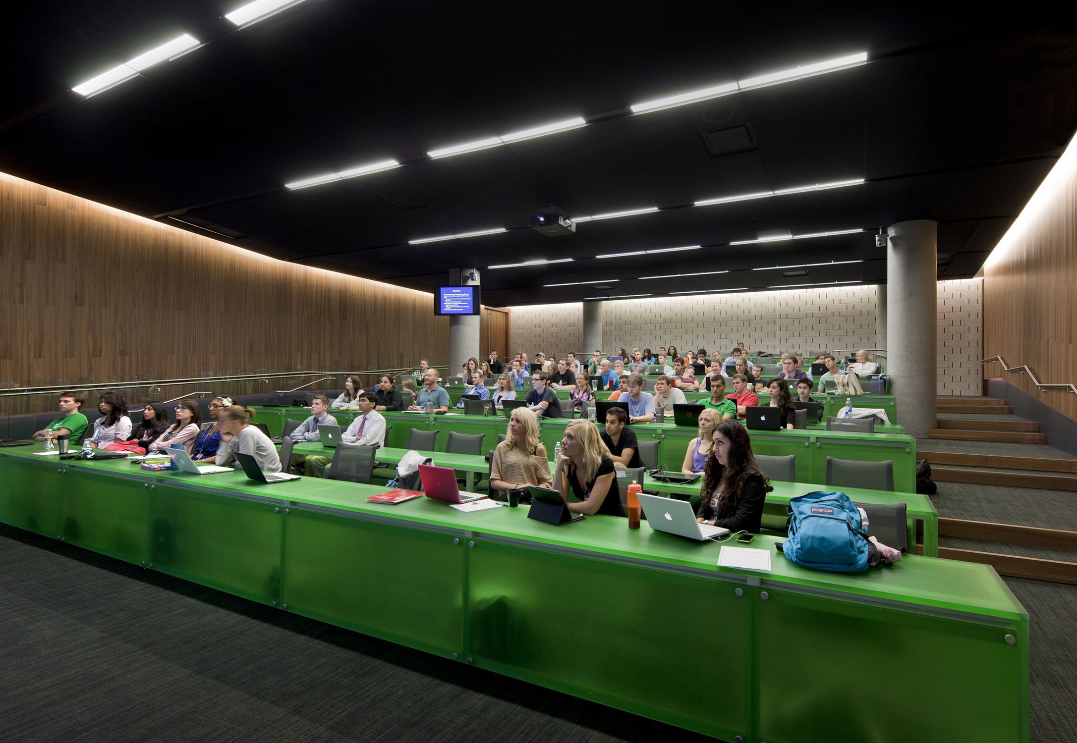 Interior image of a tiered classroom with green desks at the University of Arizona Health Sciences...