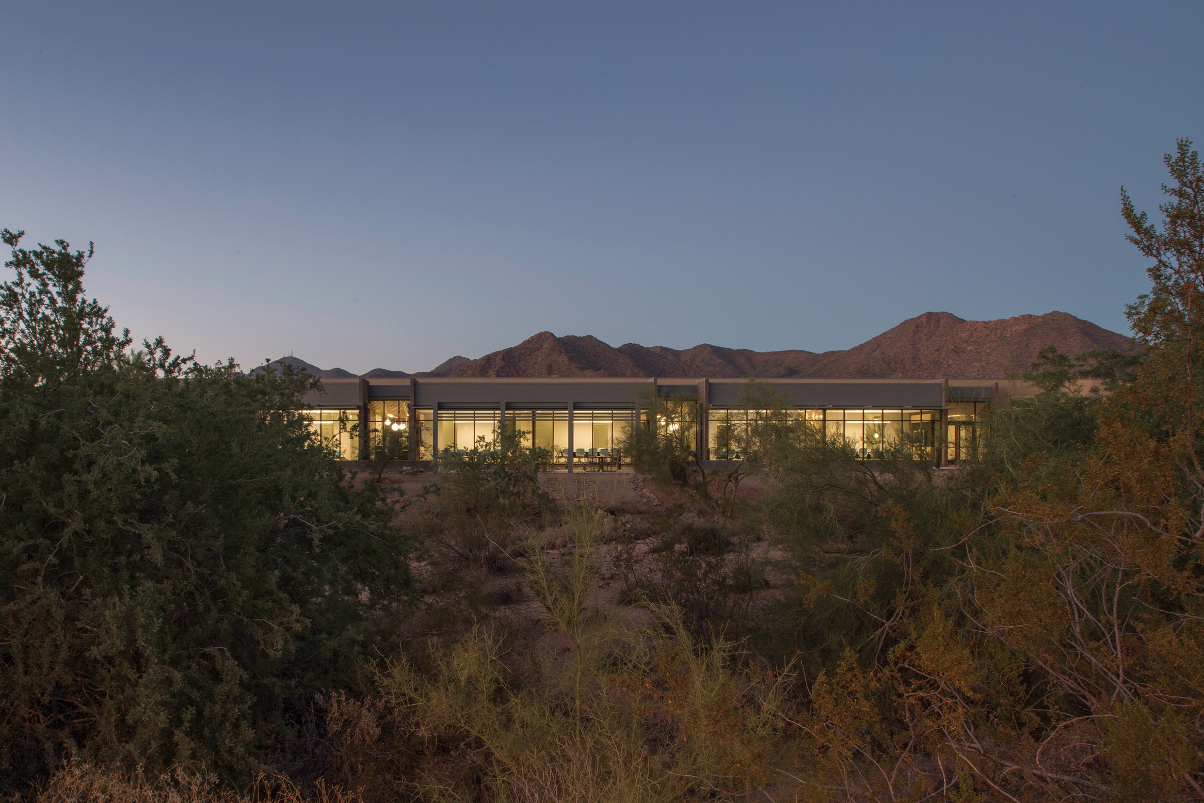 Zoomed out exterior view of Mayo Clinic Alix School of Medicine surrounded by desert landscape...