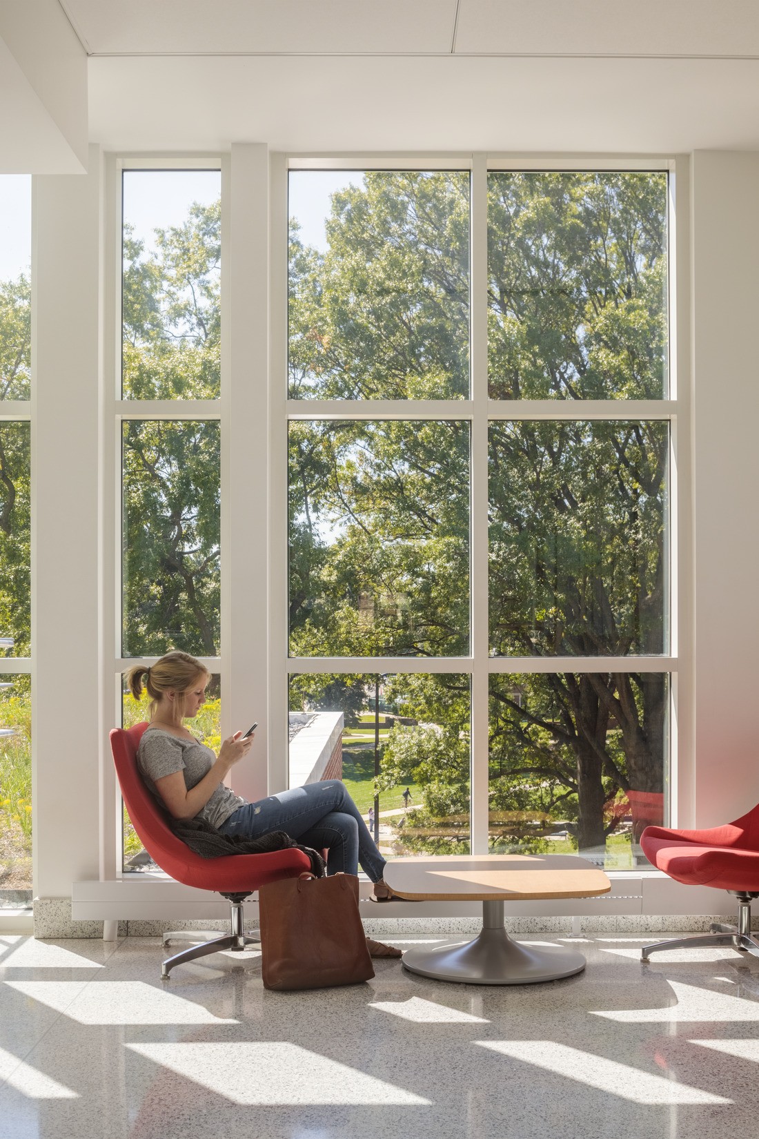 A woman reads in front of a sunlit window at Edwards St Johns Learning Center