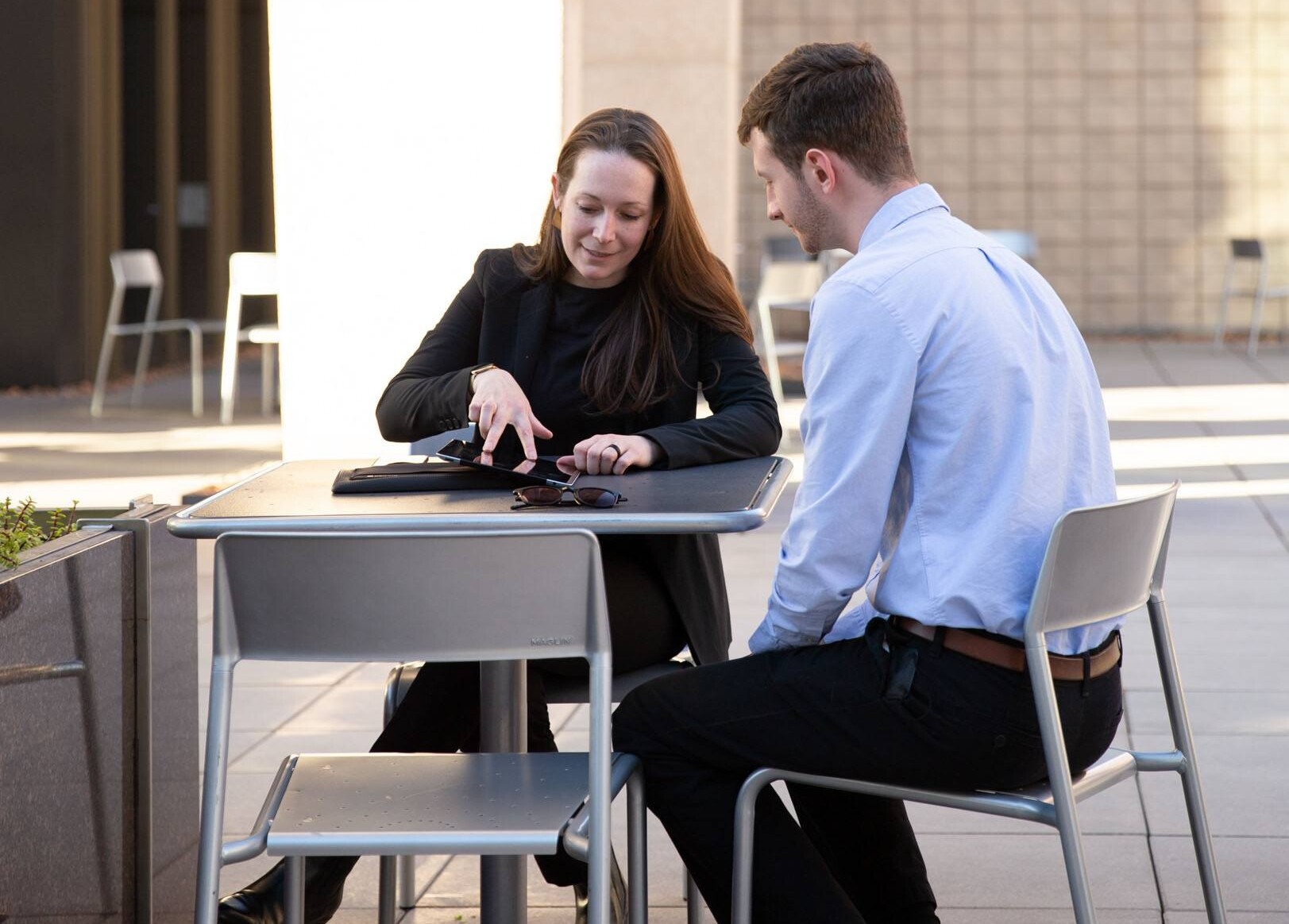 Elizabeth McLean shows a drawing on an iPad outside Arizona State University's Hayden Library
