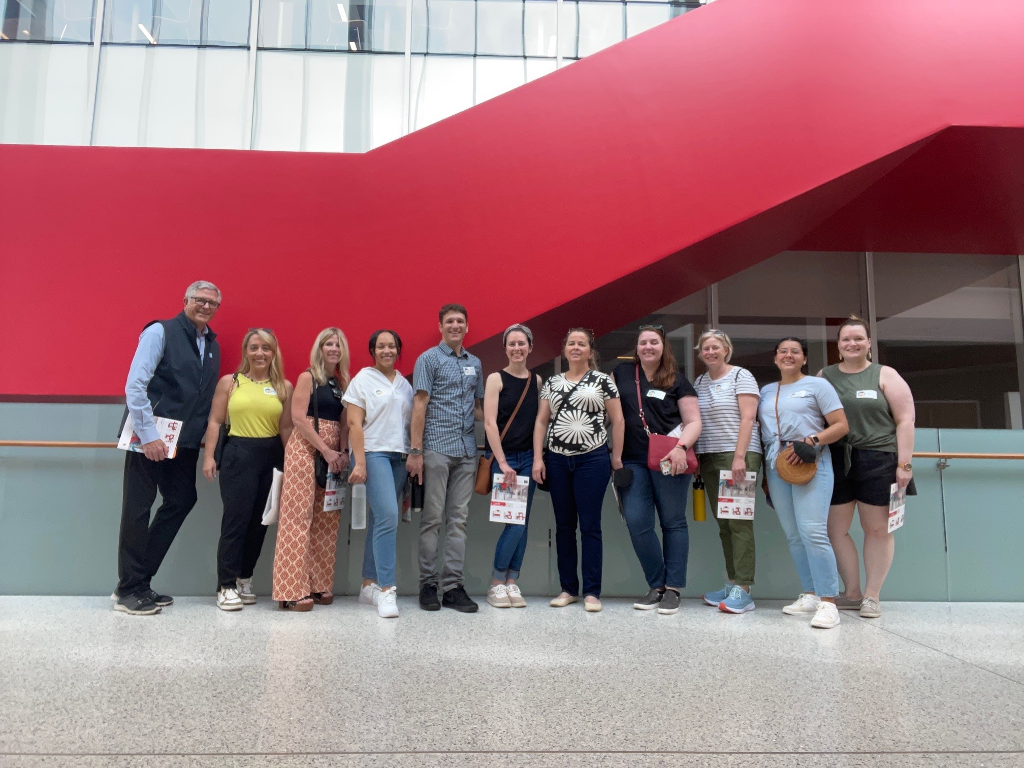 Ayers Saint Gross team members are seen in front of the stairwell at Edward St. John Teaching and...