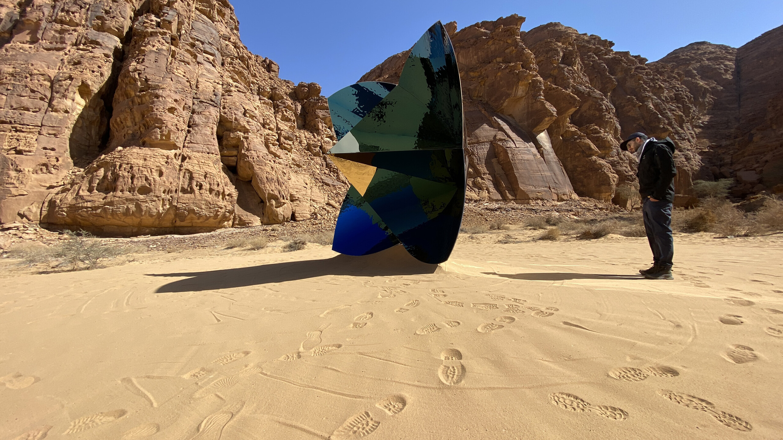 An Ayers Saint Gross team members examines art during the Desert X AlUla opening in February 2022.
