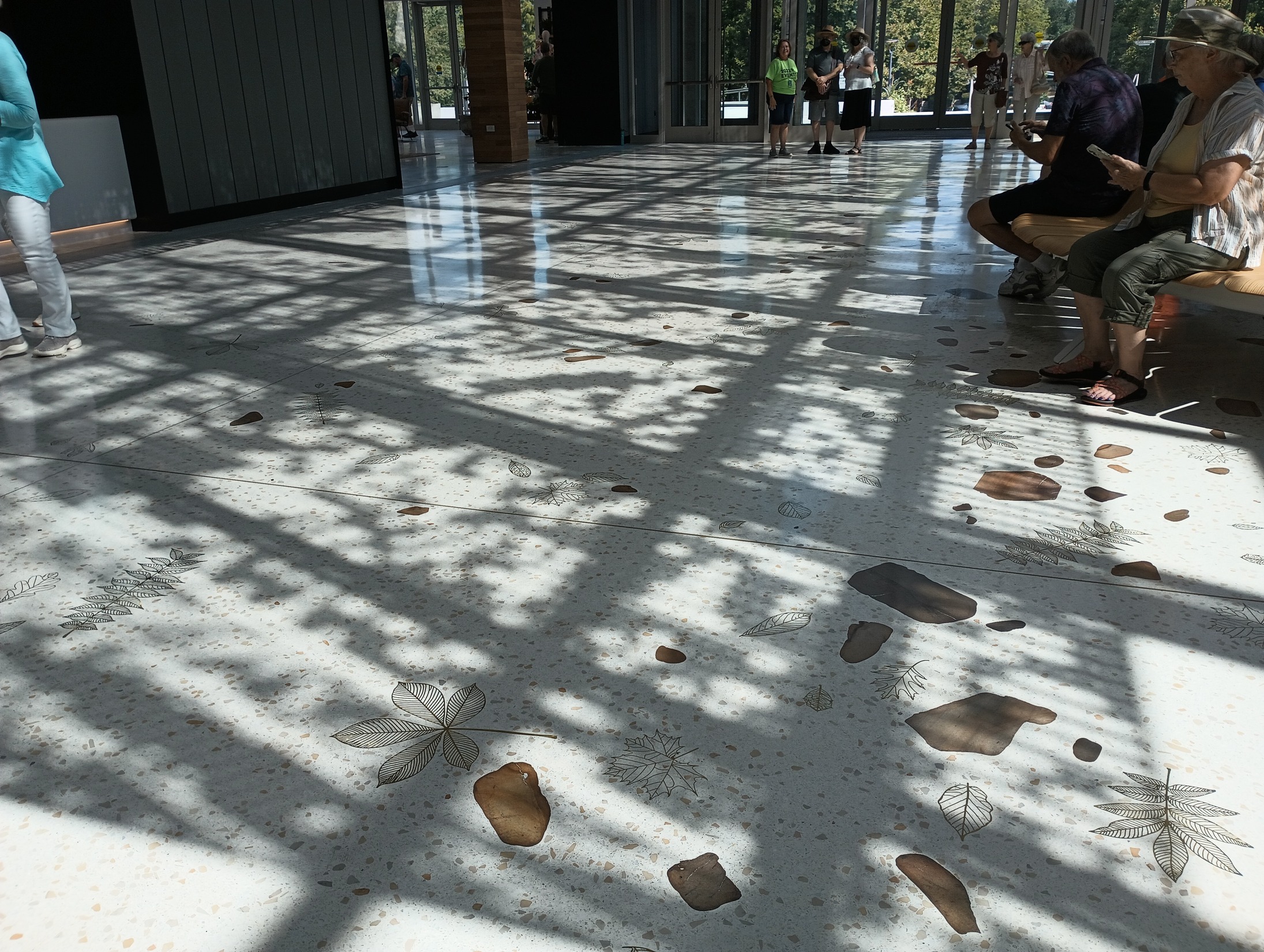 A completed view of the terazzo floor, with custom-designed brass leaves