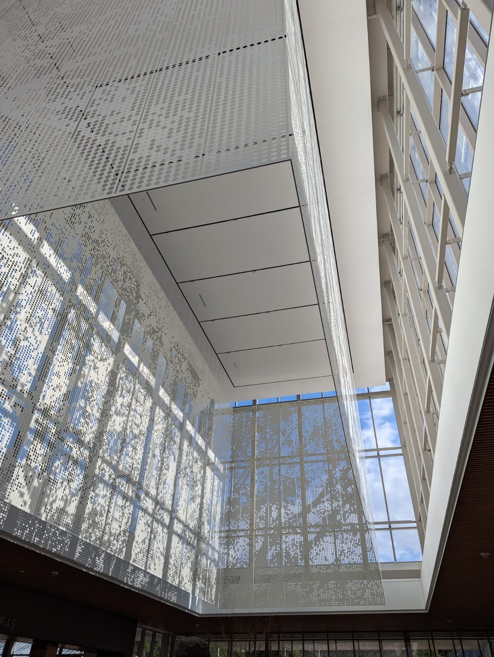 The suspended lantern scrim manipulates the sunlight to produce a dappled effect similar to that...