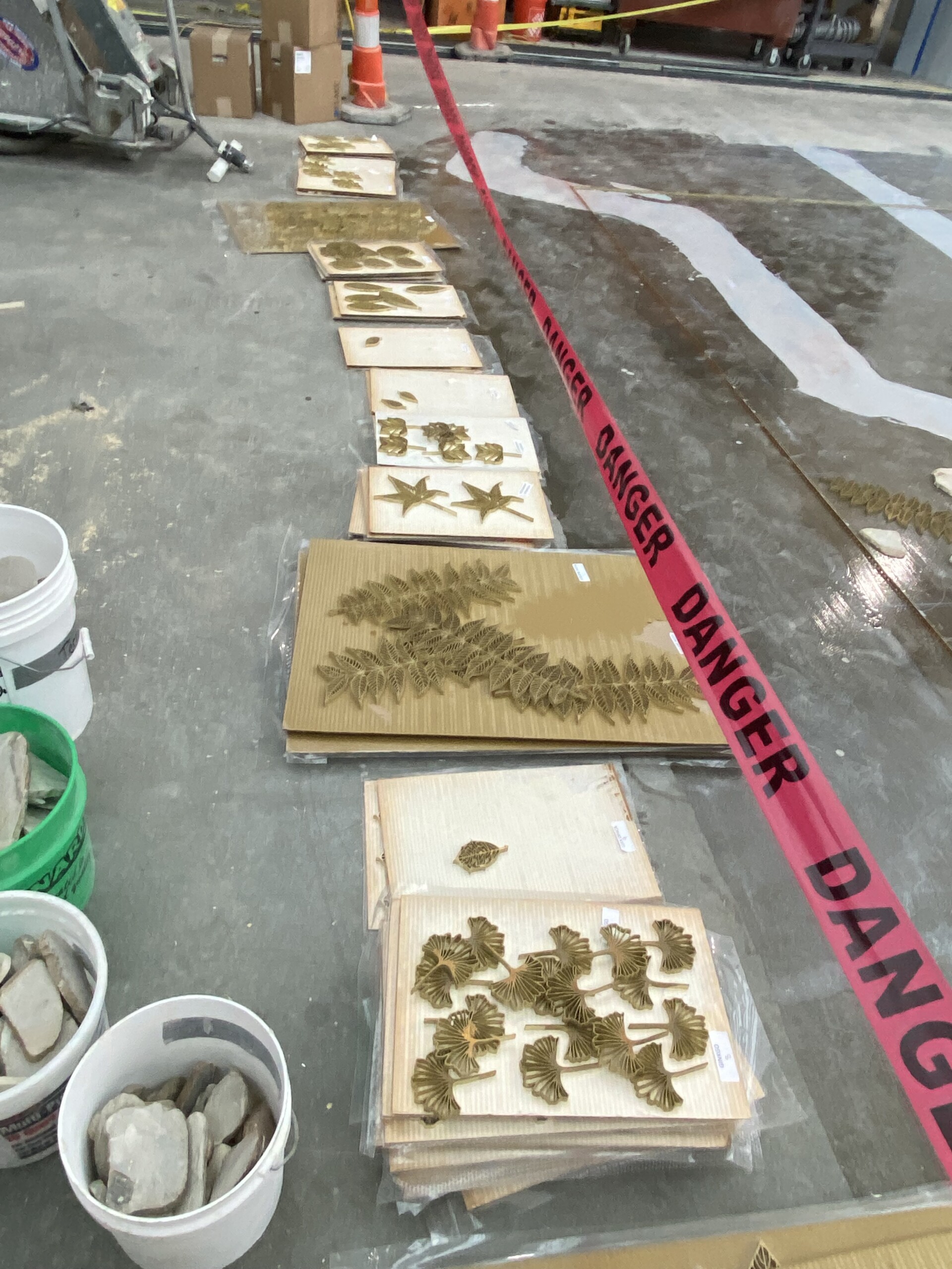 A progress photo shows the custom-designed brass inlays before they were installed into the floor...