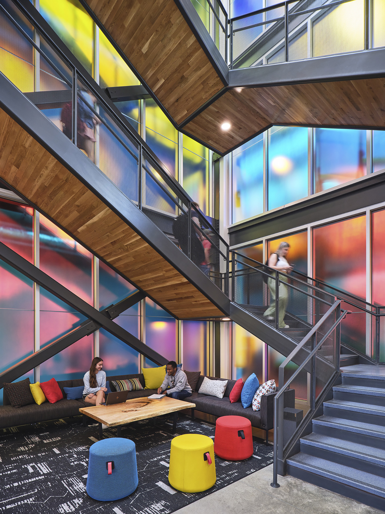 The grand stairwell for Elon University's Innovation Hall features sunlit diochromatic glass and...