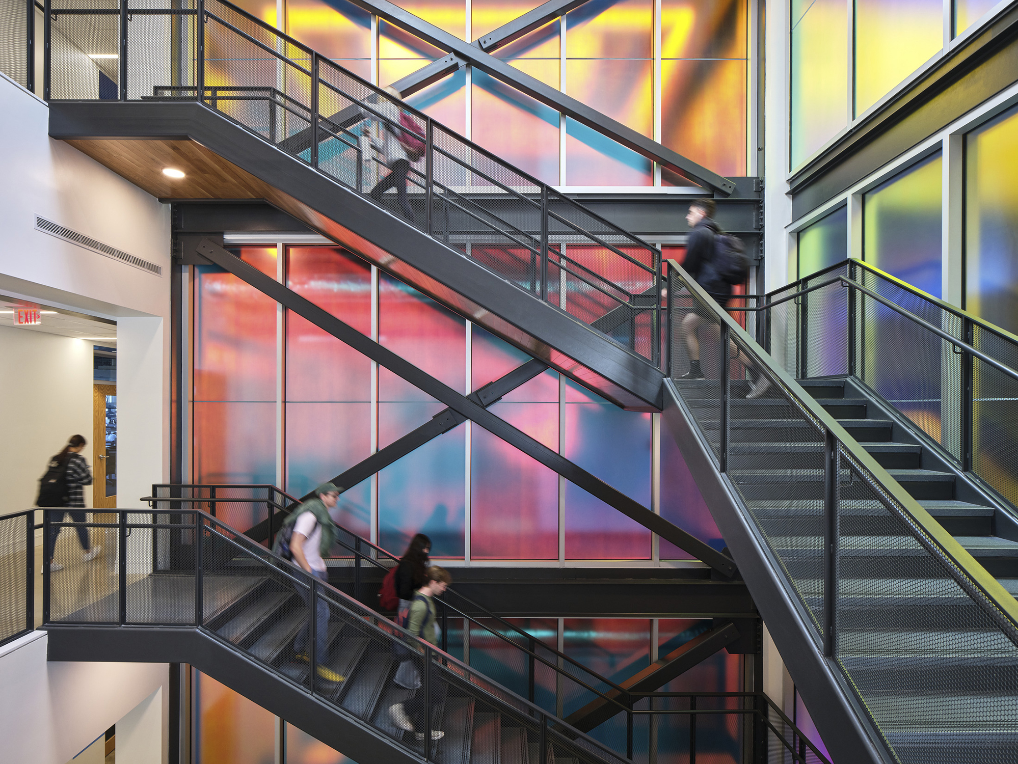 The grand stairwell at Elon University's Innovation Hall includes diochromatic glass and hexagonal...