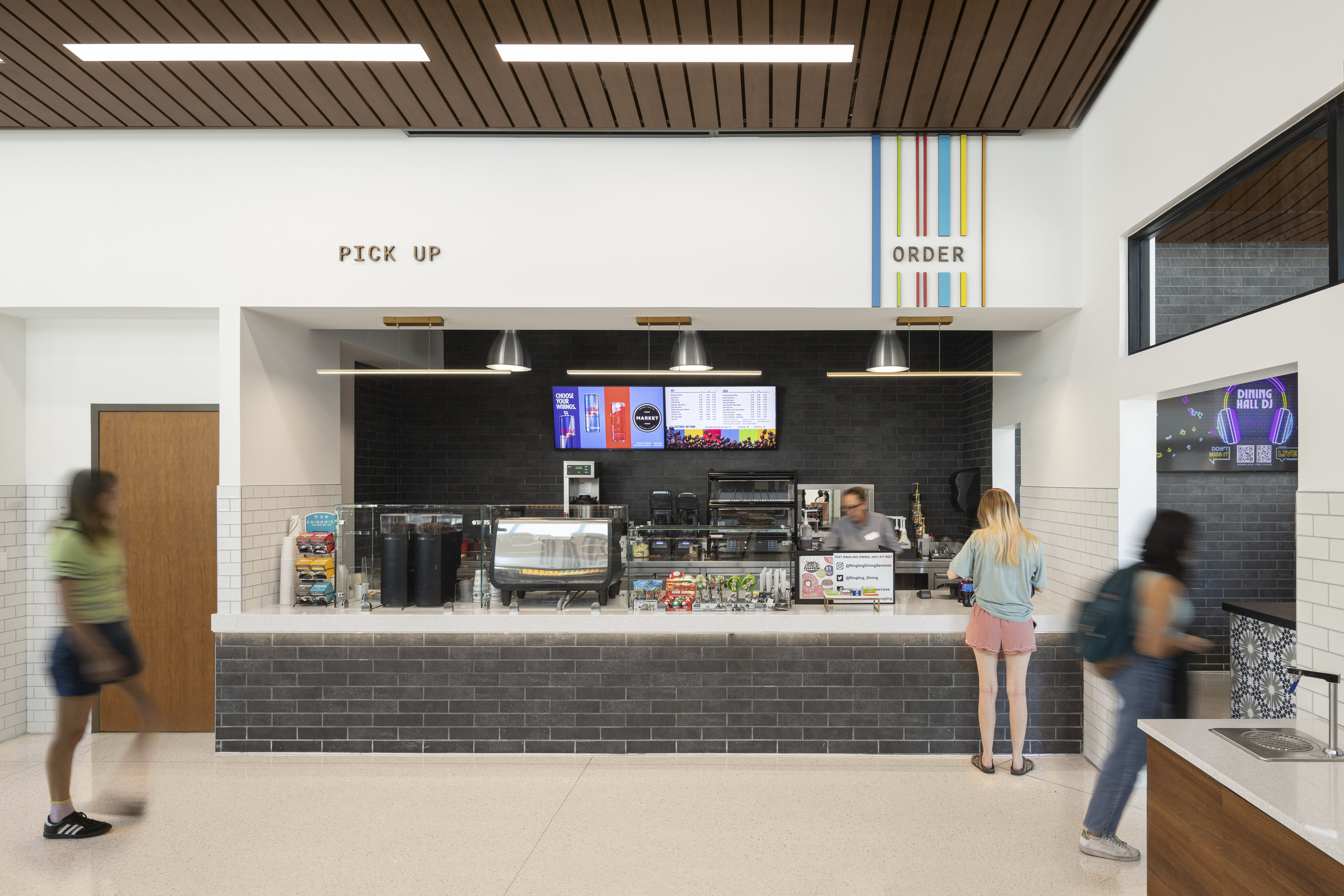 Students shop at a colorful market counter in Ringling College's Cunniffe Commons.