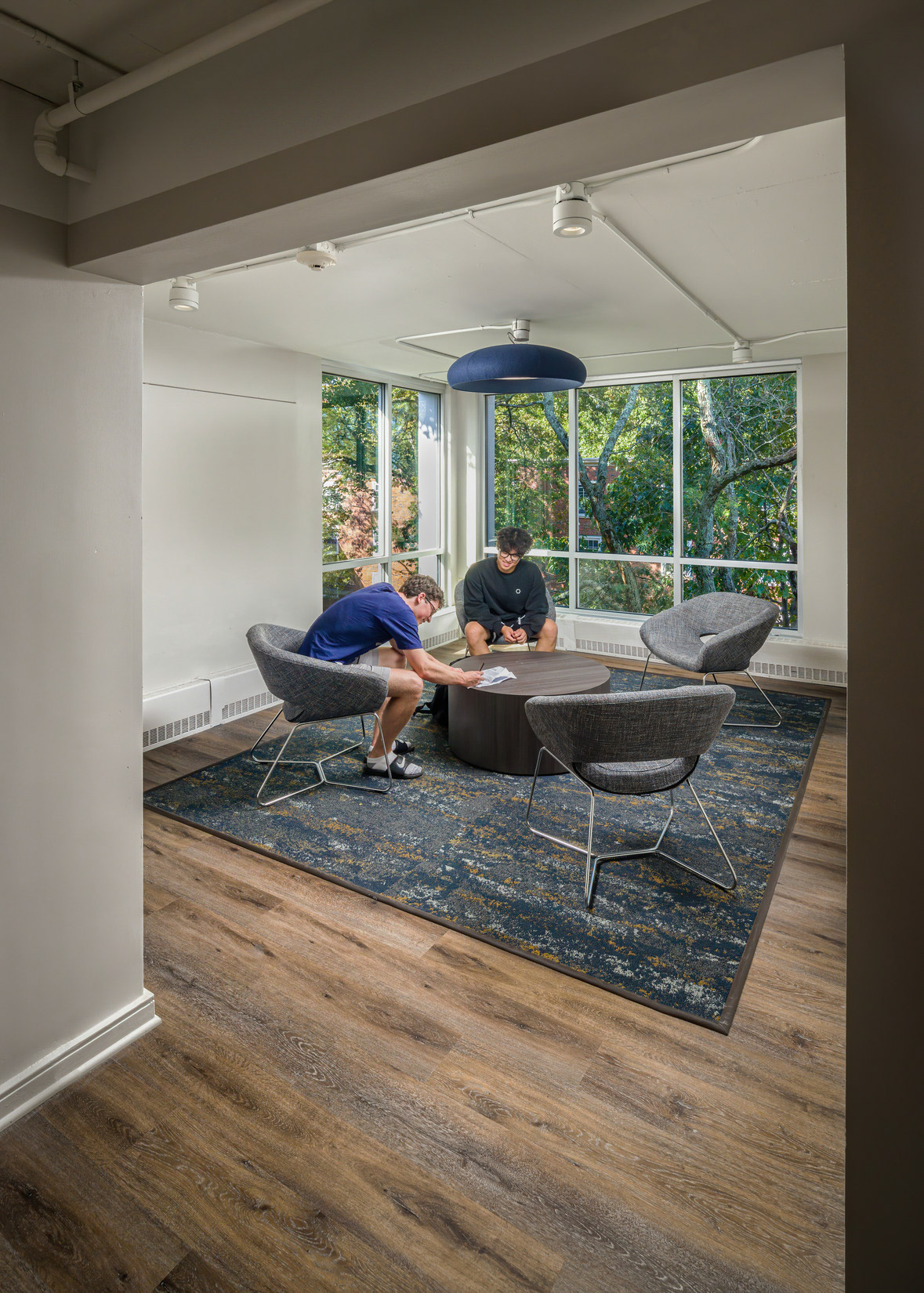 Students relax in a brightly lit lounge space
