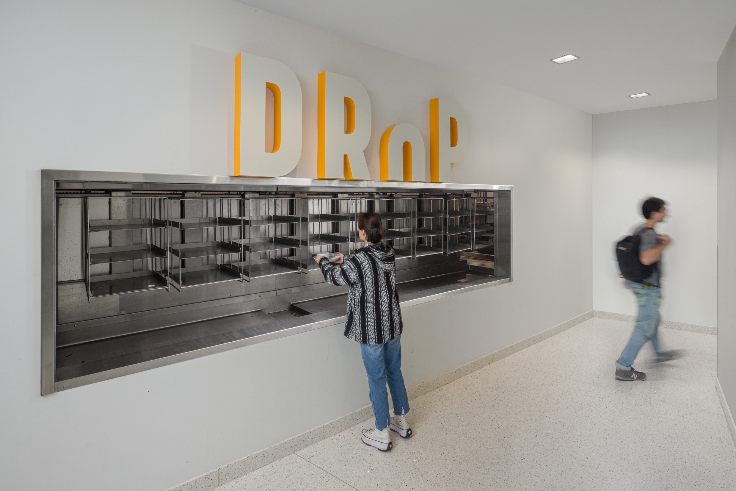 Drop signage for dish drop. Letter O appears to drop into the window.