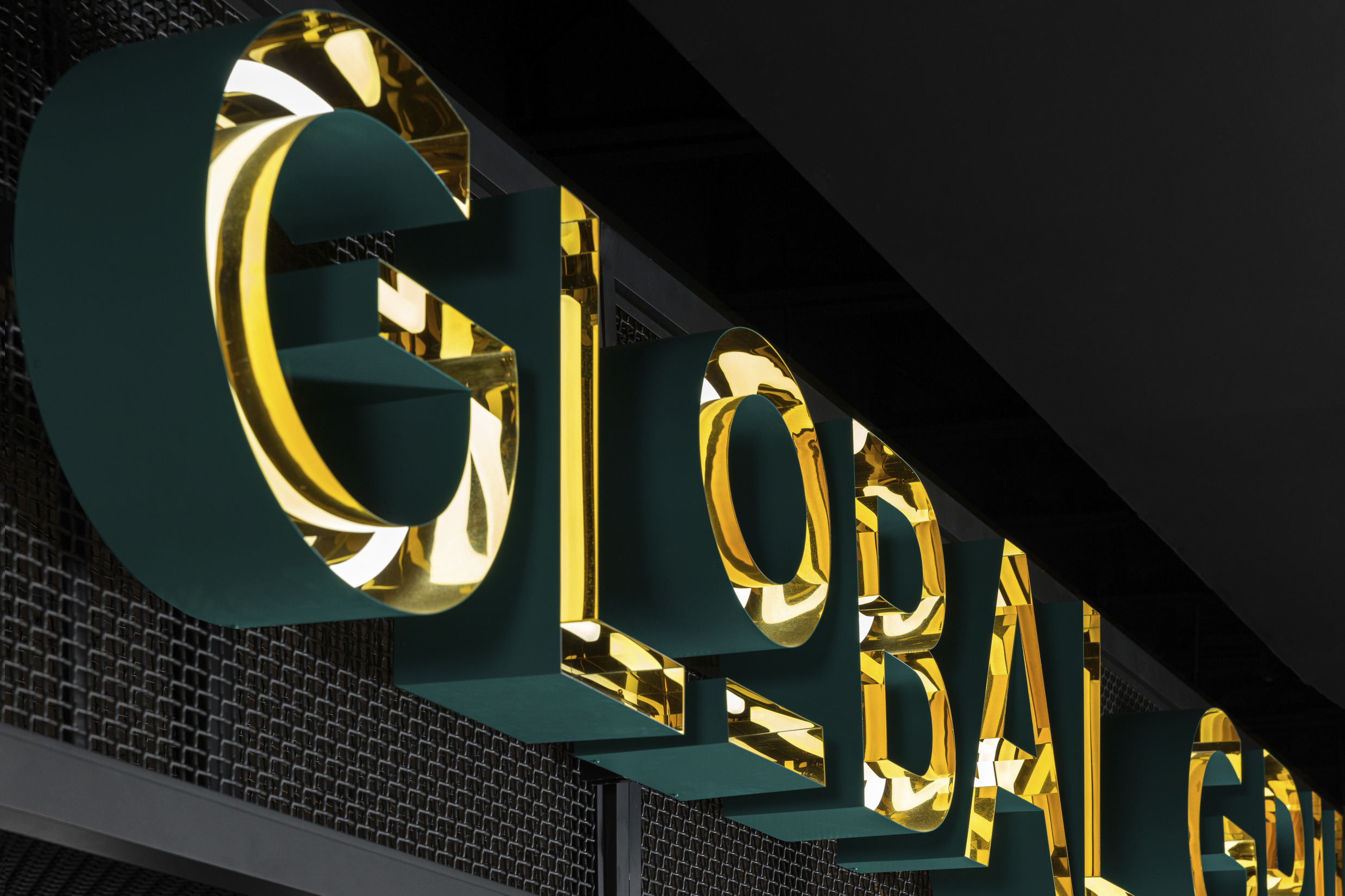 Global Grill sign with brass, neon, and teal details.