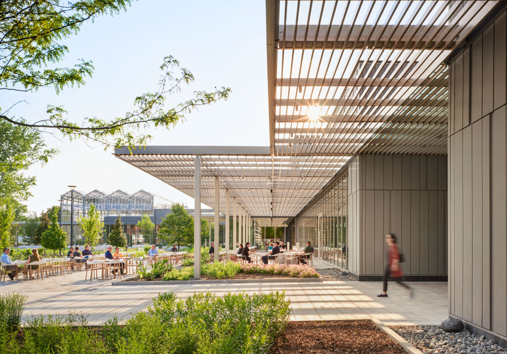 A person exits the Jack C Taylor Visitor Center at the Missouri Botanical Garden into the main...