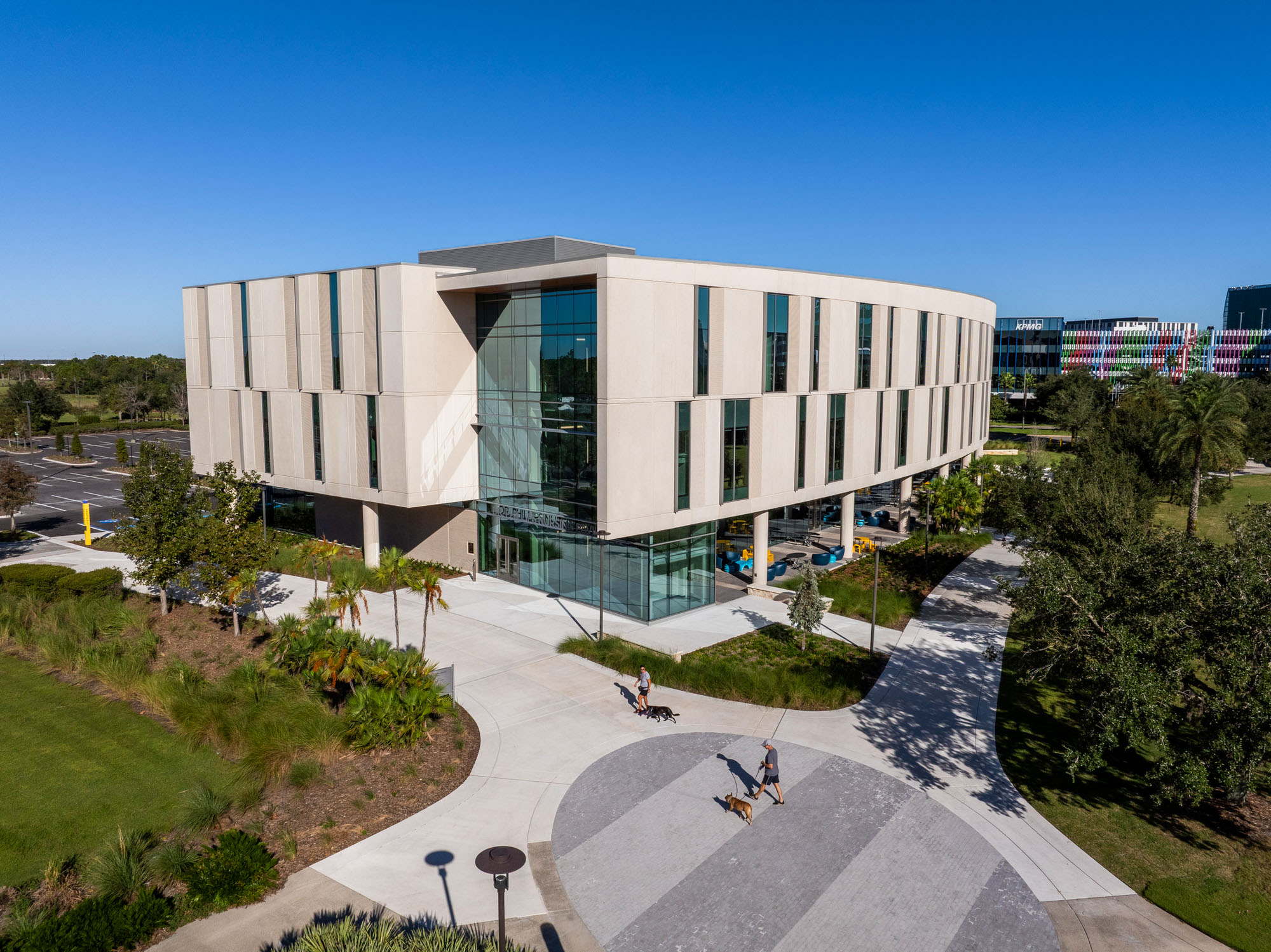 Aerial view of the UCF Dr. Phillips Nursing Pavilion highlighting its curved form, landscaped campus...