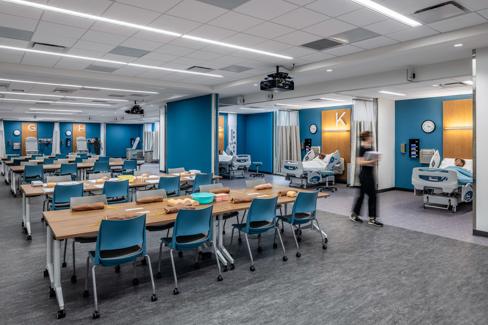 Open simulation suite with hospital beds, patient mannequins, and flexible classroom seating for...