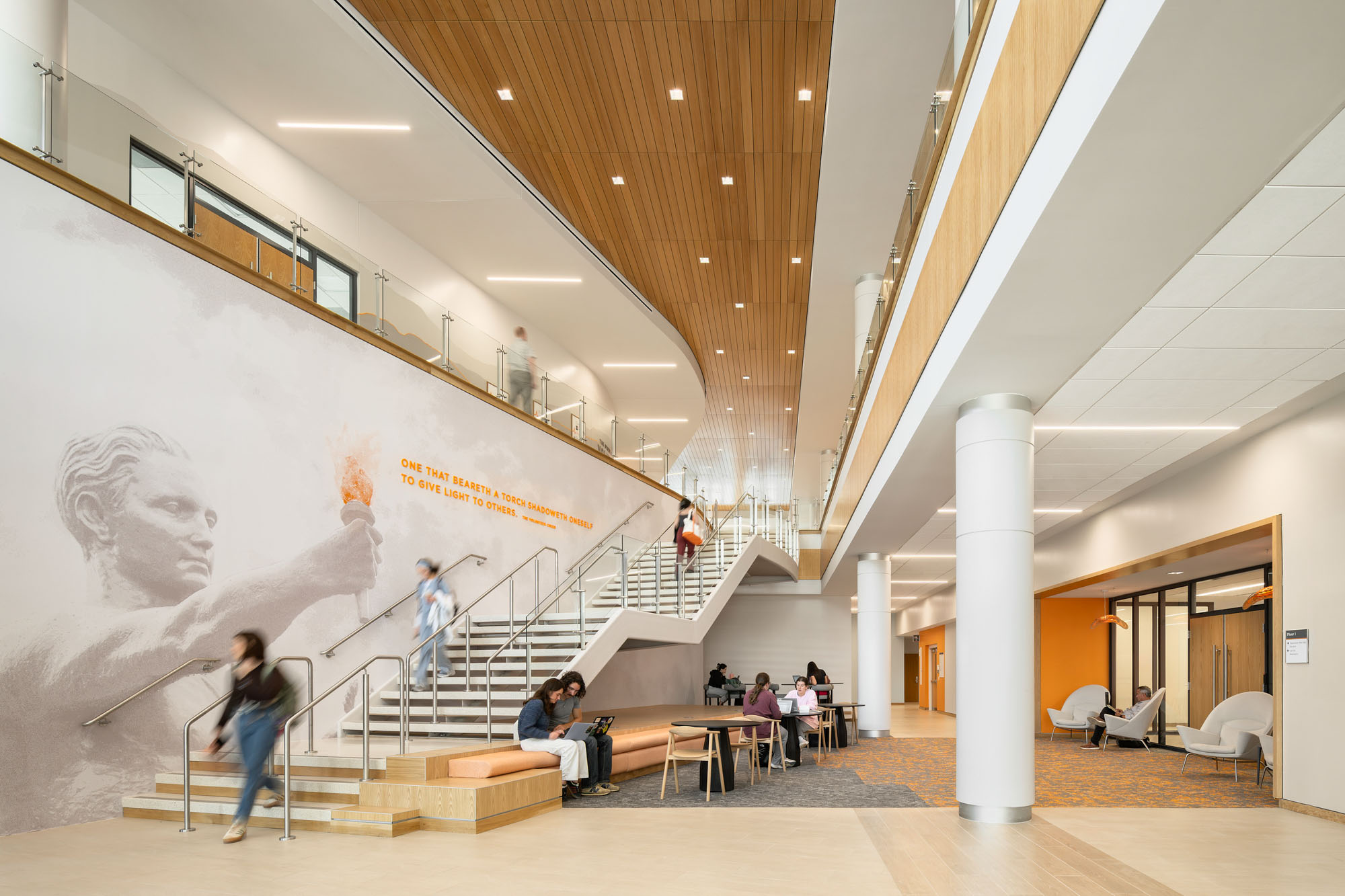 Interior view of the nursing building’s central stair, featuring an open, multi-level space with...