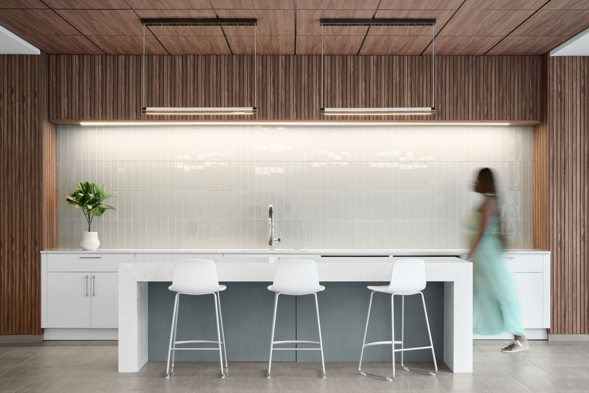 A student walks past a high work table in Banyan Residence Hall at Lynn University.